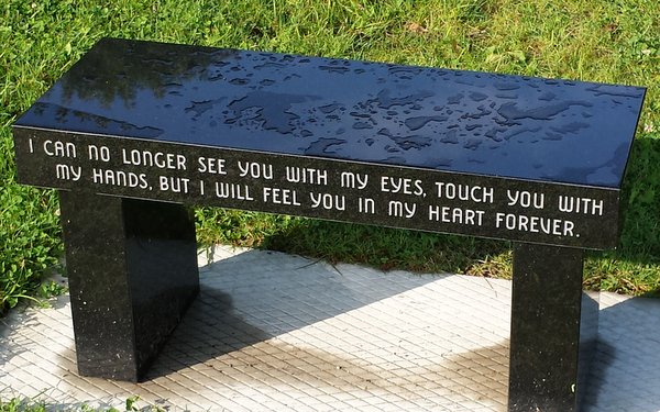 Closeup of inscription of memorial bench at the Memorial for Maine Murdered Children in Augusta, ME. 