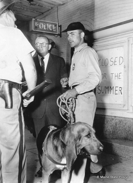 1964-NH Trooper handler Eugene Meier and "Chief" the hound that found alleged murderer Joseph McDonald. On left, Public Safety Commissioner Robert Rhodes. Photo taken in Somersworth NH. 